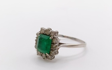 An 18ct white gold, emerald and diamond cluster ring