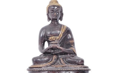 An early 20th century Chinese two tone bronze figurine depic...