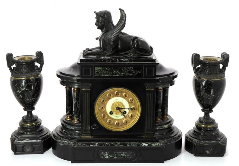 Black marble, green marble and patinated bronze Return from Egypt style mantel set, including a clock surmounted by a recumbent sphinx (H 44 x W 33 x D 15 cm) and a pair of vases (H 30 cm). Circa 1880 / 1900. Slight marble scratches. Functional...