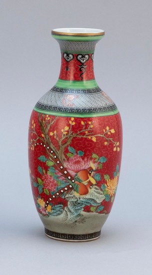 CHINESE FAMILLE ROSE PORCELAIN BALUSTER-FORM VASE Decoration of exotic birds in a floral landscape on a ruby red ground. Four-charac...