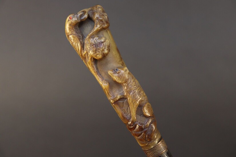 Cane with gnarled wooden shaft. Horn knob carved with the fable of the crow and the fox. Height 93 cm