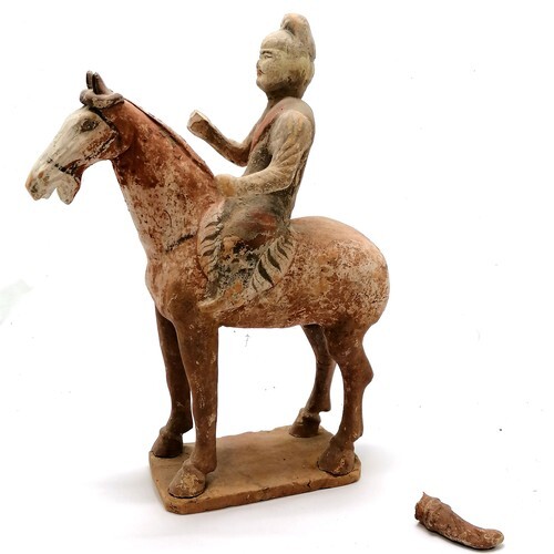 Chinese pottery tomb figure of a horse and rider. Painted an...