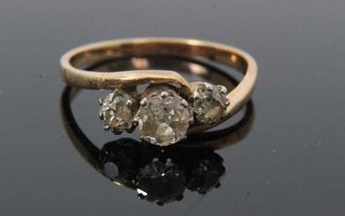 Diamond three stone ring with three old cut diamonds in cross-over claw setting on 9ct gold shank. Estimated total diamond weight approximately 0.65cts. Ring size O½