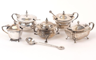 Five Edwardian and later silver mustards, and several condiment spoons, the mustards including one rounded example raised on three pad feet, Chester, c.1922, Colen Hewer Cheshire; a Mappin & Webb example, Birmingham, c.1906, with a matched mustard...