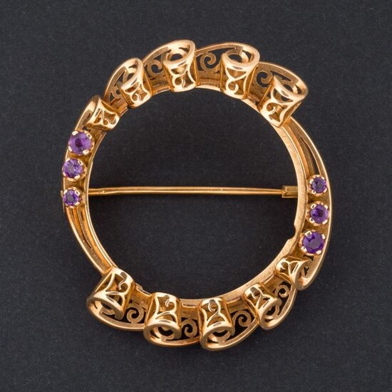 Gold brooch setting with openwork volutes, set with amethysts.