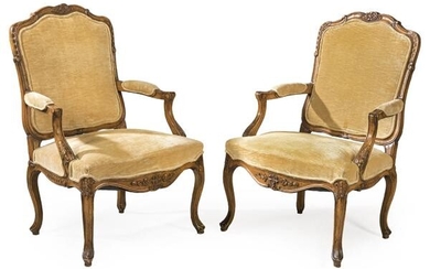 Pair of Louis XV style armchairs in carved walnut
