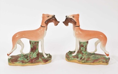 Pair of Staffordshire pottery models of standing greyhounds