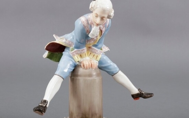 Polychroom beschilderd porseleinen figuur: man springt over paaltje, uitvoering...