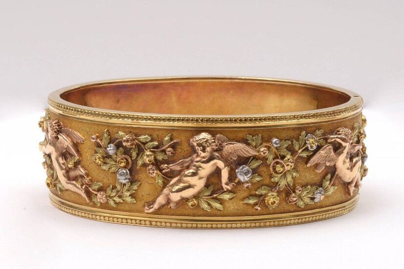 Rigid bracelet in 18K yellow, pink and white gold decorated with a "Frieze of angels and flowers". Period: Napoleon III. Dim. inside: +/-5.5x4.5cm. Total weight: +/- 57.85gr.