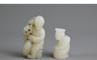 TWO CHINESE WHITE JADE PENDANTS. To include a figure of a ma...