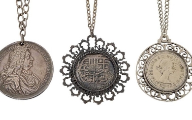 Three coin pendant necklaces, comprising: a pendant mounted reproduction 8 reale coin; a pierced commemorative medallion dated 1694, commemorating Louis IV of France; and a pendant mounted silvered penny, all suspended from neckchains (3)
