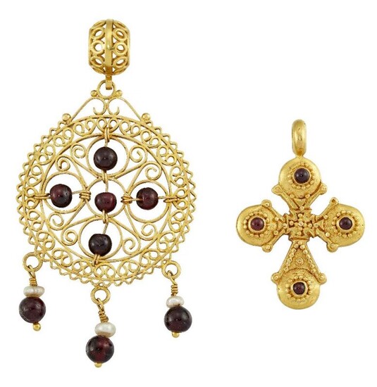 Two garnet-set pendants, the first modelled as...