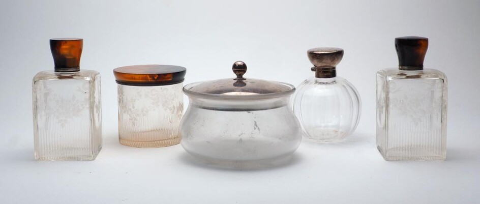 Two silver lidded clear glass jars, 20th century, to include a rounded jar with fluted body, the lid with hallmarks for Birmingham, 1910, 12.5cm high, and a bulbous jar, the lid with hallmarks for London, 1916, together with three tortoiseshell...