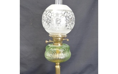 Victorian oil lamp having green glass reservoir supported on...