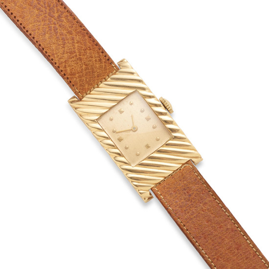 a gold leather strap manual curved wristwatch