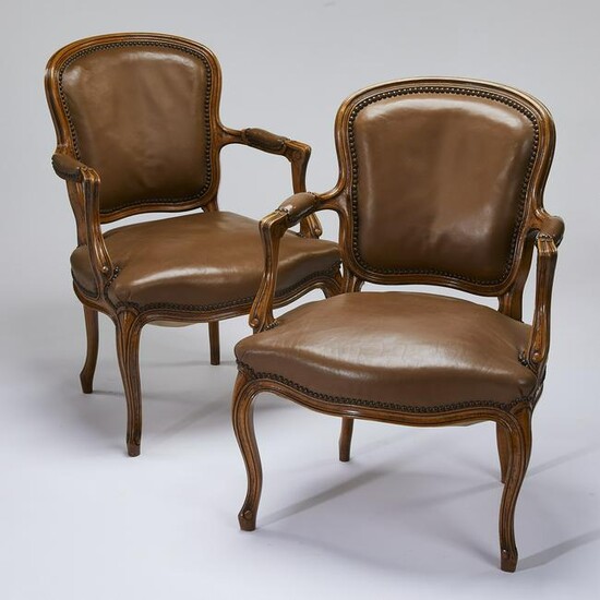 (2) Early 20th c. walnut fauteuils in leather