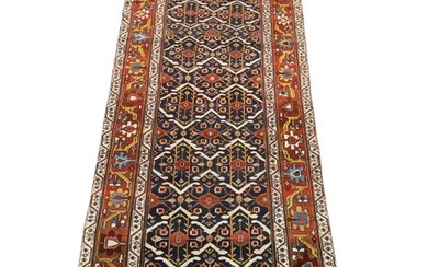 Antique Luri-Baktiari tribal rug, all over design with stylised flower and foliage on a blue base. Dated 1337=1919. Persia. 431×161 cm.