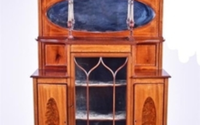 An Edwardian mahogany and inlaid display cabinet with broken scroll pediment over a mirrored top, the astral glazed central...