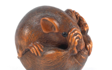 A wood netsuke of a coiled mouse