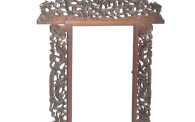 A 19th century Chinese hardwood screen. Heavily carved and detailed being raised on dragon foot base with scrolled dragon pierced uprights to temple deity over monogram Chinese character marked top / seal mark. Measures 83cm high x 78cm wide