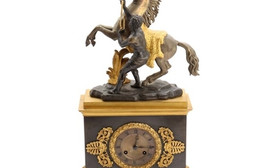 A 19th century Late empire gilded and patinated bronze mantel clock, surmounted by bucking horse and man by G. Coustou. H. 51 cm.