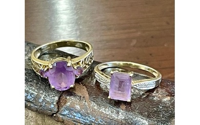 A 9ct gold lady's dress ring set a central amethyst and two ...