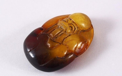 A CHINESE CARVED AMBER FIGURE OF SHOU LAO - carved in