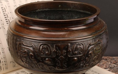 A Chinese patinated bronze ovoid pedestal jardiniere, relief...