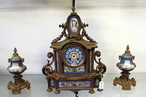 A FRENCH ORMOLU AND PORCELAIN CLOCK GARNITURE