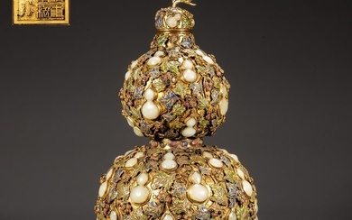 A GILT BRONZE BOTTLE, INLAID WITH JEWELS.