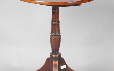 A George III mahogany circular tip-top wine table, raised on tripod legs, height 73cm, diameter 55cm