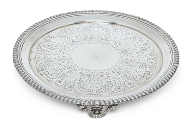 A George IV silver salver, London, 1822, Philip Rundell, of circular form with gadrooned edge, the later decorated base engraved with stag crest and raised on three bracket feet, 25.8cm dia., approx. weight 20.3oz