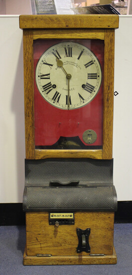 A George V British Time Recorder Co Ltd oak clocking-in clock with eight day movement and signed pai