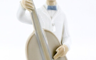 A Lladro Porcelain Figurine of a Boy Playing Cello, Spain