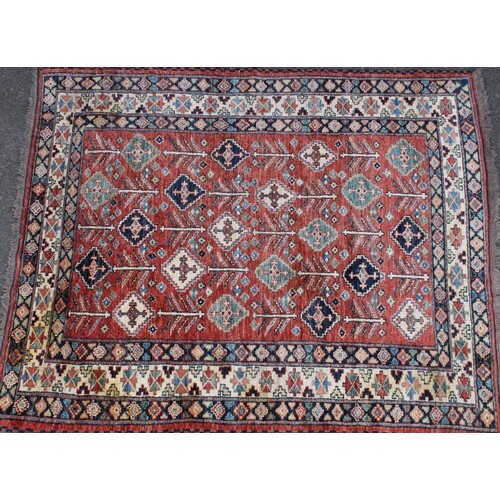 A Middle Eastern woollen carpet, worked in the traditional m...