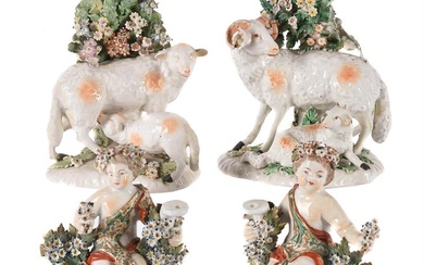A PAIR OF DERBY BOCAGE GROUPS OF EWES AND LAMBS AND A PAIR DERBY FIGURAL CANDLESTICKS