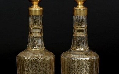 A PAIR OF GILT DECORATED BACCARAT DECANTERS