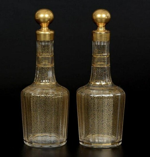 A PAIR OF GILT DECORATED BACCARAT DECANTERS