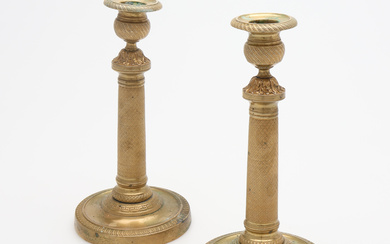 A PAIR OF LATE EMPIRE GILT BRASS CANDLESTICKS, probably France, first half of the 19th century.
