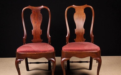A Pair of George II Splat Back Chairs,. The dipped cresting rails and broad back splats carved with