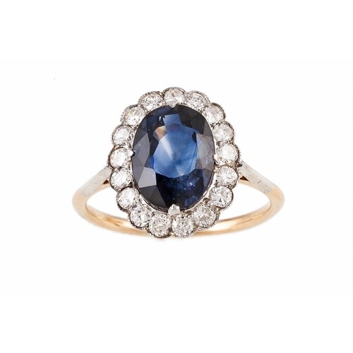 A SAPPHIRE AND DIAMOND CLUSTER RING, the oval sapphire to a ...