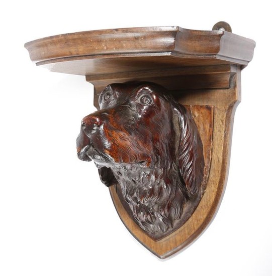 A VICTORIAN CARVED WOOD SPANIEL WALL BRACKET BY...