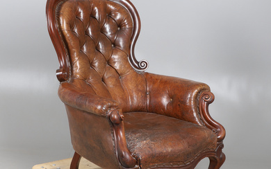 A VICTORIAN MAHOGANY LEATHER BUTTON BACK LIBRARY ARMCHAIR.