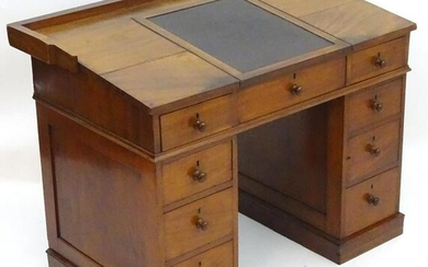 A Victorian mahogany clerks desk with a hinged writing