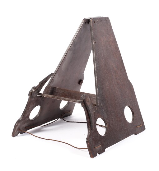 A Victorian stained oak folding book stand, of triangular form, with pierced circular ornament