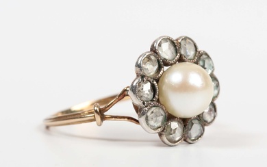 A gold, diamond and cultured pearl cluster ring, mounted with the single cultured pearl within a sur