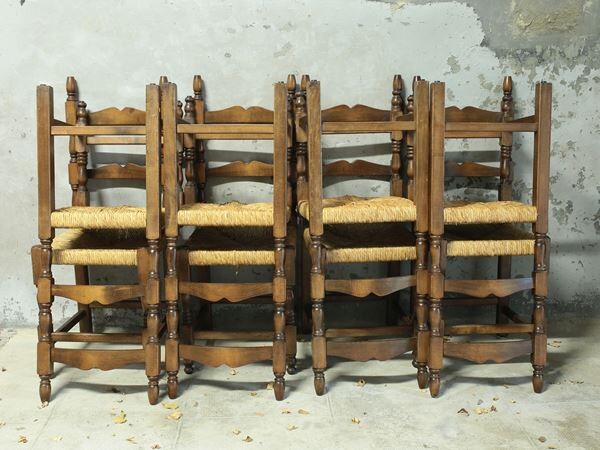 A group of eight walnut rustic chairs