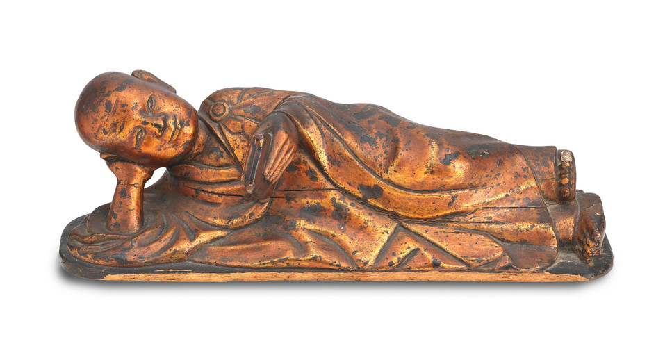 A lacquered wood reclining Buddha