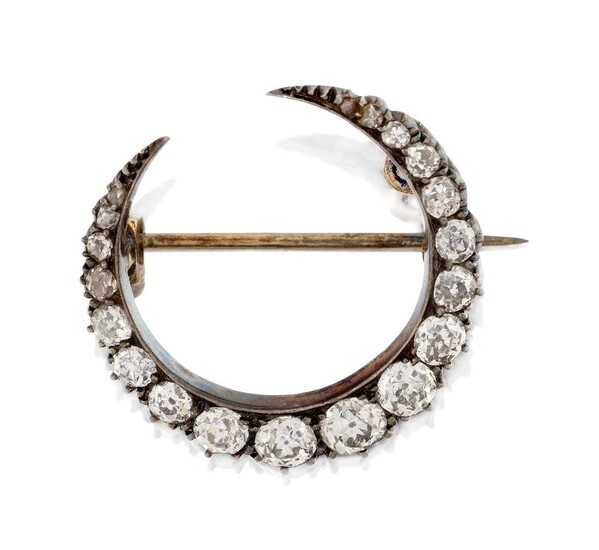 A late Victorian diamond crescent brooch, designed as a graduated line of old-brilliant-cut diamonds, set in silver and gold, c.1880, approx. width 2.4cm, in fitted case