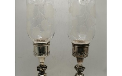 A pair of Elizabeth II silver hurricane lamp candlesticks, m...